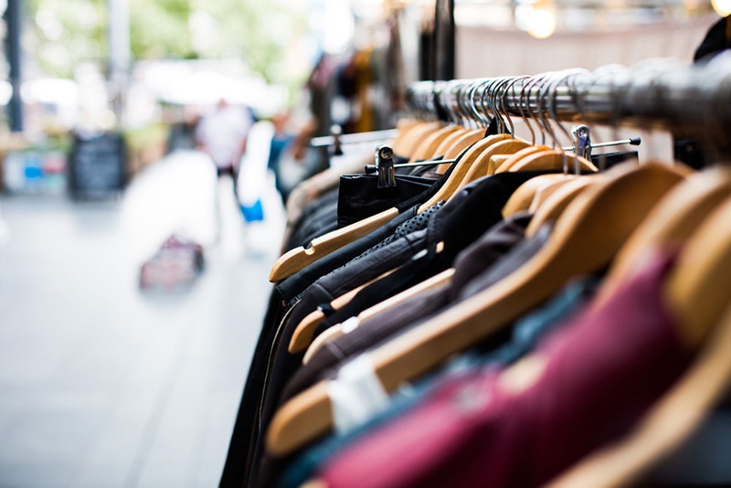 Clothes lined up on hangers