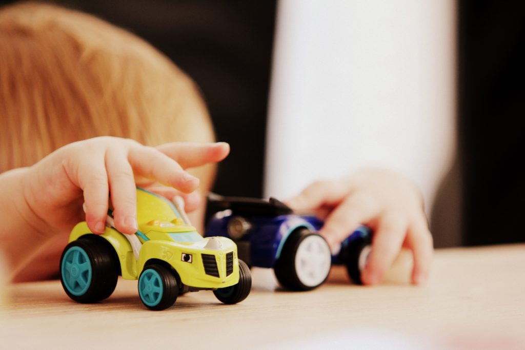 A child plays with toy cars